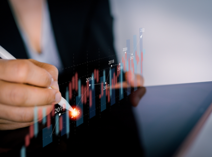 Woman with tablet looking at stock market