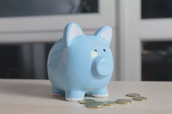 Blue piggy bank with change